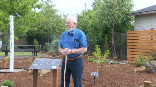 Darrell Ward speaking in front of the garden